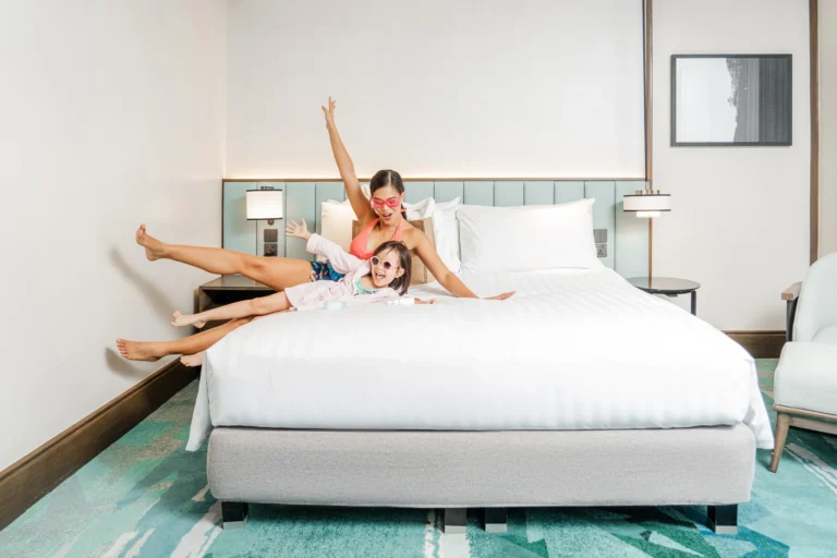Mother and Daughter lying down in bedroom excited